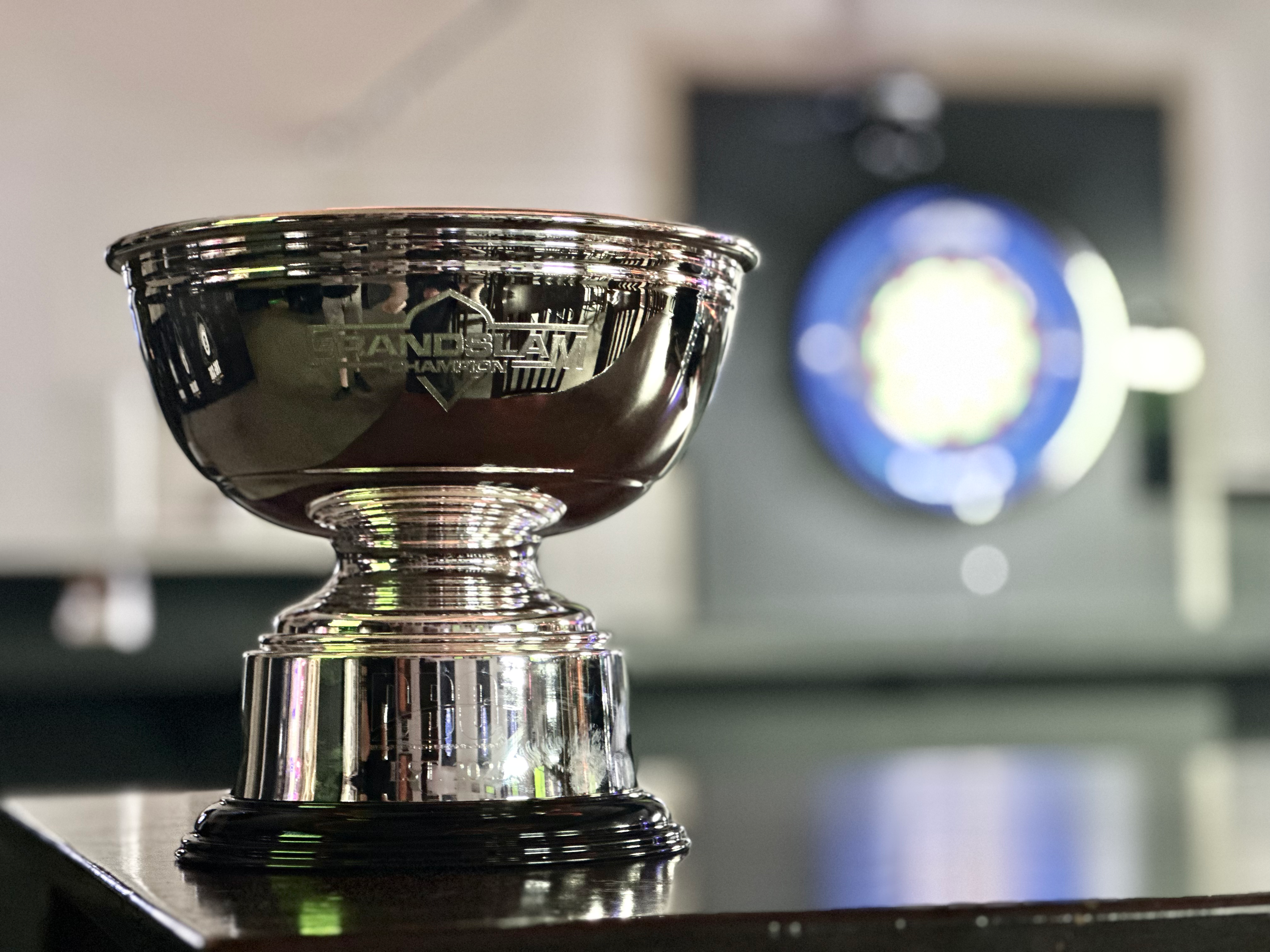 Deaf Darts championship trophy in front of a dartboard